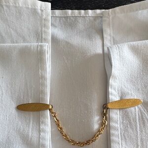 Vintage gold tone sweater or scarf guard.